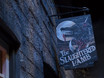 The Bar is called The Slaughtered Lamb. The hanging sign depicts a skewered wolf's head