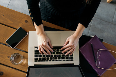 Girl working on a notebook at home.