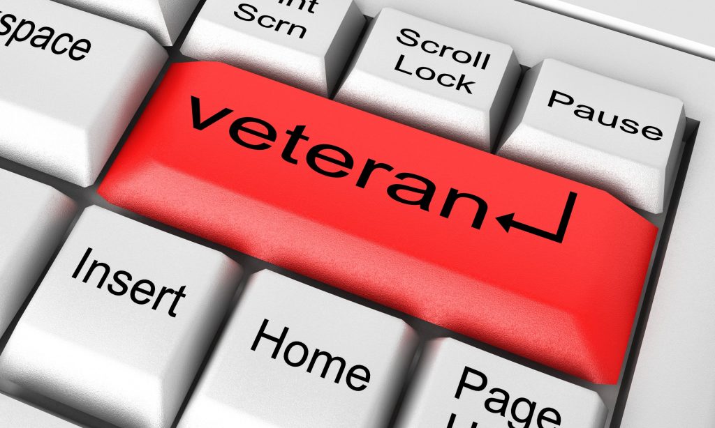A red enter keyboard key with the word "veteran" on it