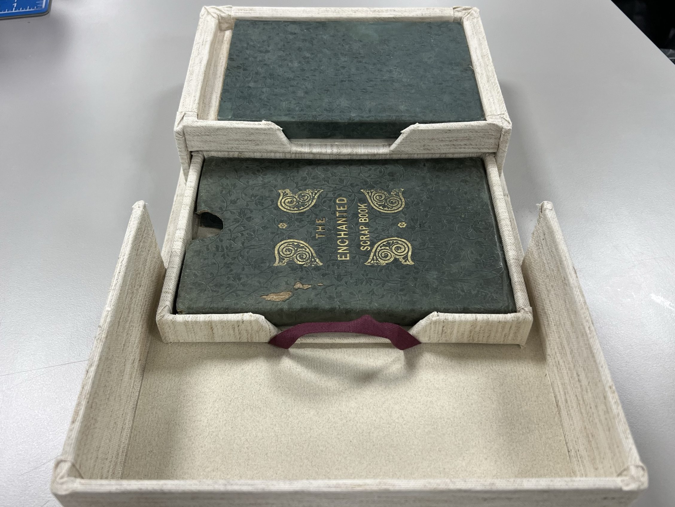 Image of an open clamshell box with a drawer pulled out.