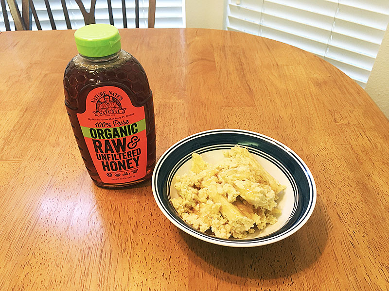 A serving of spoon bread drizzled with honey.