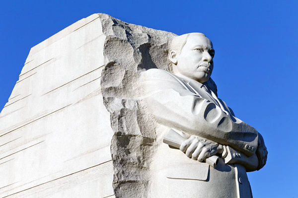 Top of Martin Luther King, Jr. monument in three-quarter pose against a blue sky.
